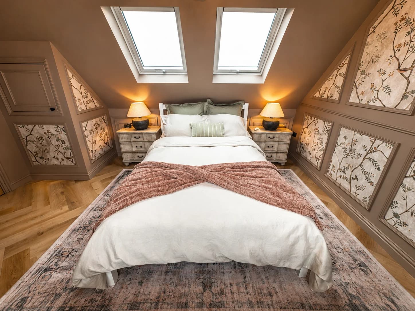 Attic bedroom with bespoke panelled feature walls, herringbone floor and soft lighting