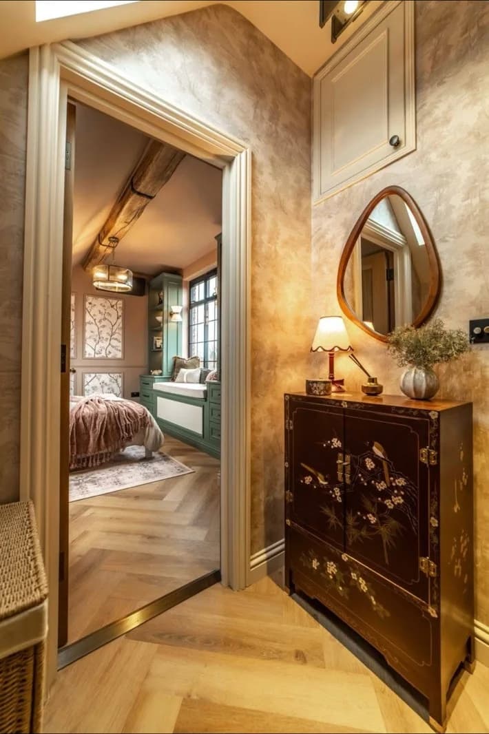 Loft landing with bespoke panelling and herringbone flooring looking through to the finished bedroom