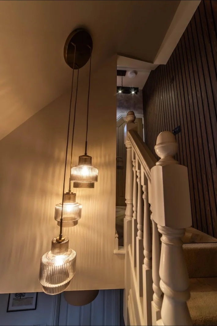 Stairway to the loft with slatted timber panelling, new balustrade and pendant lighting
